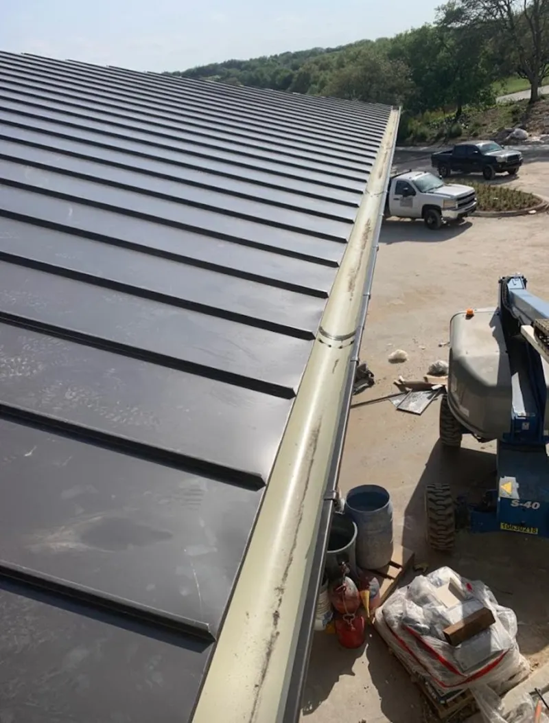 Standing seam panel and gutter detail on a metal roofing jobsite in Spring Valley